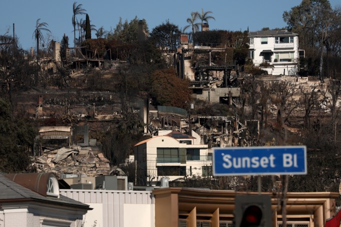 PACIFIC PALISADES, CALIFORNIA - JANUARY 14: Homes that were destroyed by the Palisades Fire are seen from Sunset Boulevard on January 14, 2025 in Pacific Palisades, California. The Palisades and Eaton Fires erupted hours apart one week ago during an unprecedented wind event that brought hurricane-force winds to the greater Los Angeles area. Both fires spread at a critical rate, with the high winds pushing embers into homes and raining down into neighborhoods miles ahead. Since starting, the fires have collectively charred nearly 38,000 acres, and an estimated 16,500 structures have been destroyed. The Palisades Fire is 17% contained, while the Eaton Fire is at 35% containment. (Photo by Justin Sullivan/Getty Images)